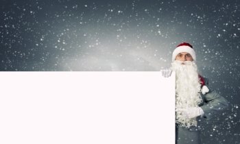 Santa with banner. Businessman in santa hat with white blank banner