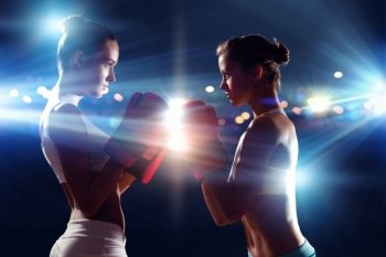 Two boxer women. Two boxer women in gloves greet each other before fight
