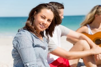 Portrait of young woman on beach. Portrait of young woman on beach with his friends on background