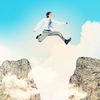 Businessman jumping over gap. Image of young businessman jumping over gap