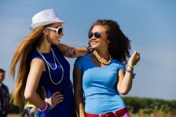 Youth and friendship. Attractive young women having fun outdoors. Summer vacation