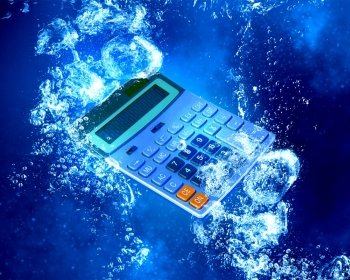 Calculator under water. Calculator item sink in clear blue water