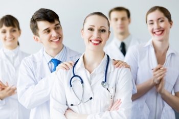 Successful female doctor. Attractive female doctor in uniform congratulated by colleagues
