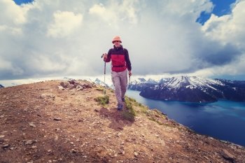 Hike in Canada. Hiking man in Canadian mountains. Hike is the popular recreation activity in North America. There are a lot of picturesque trails.