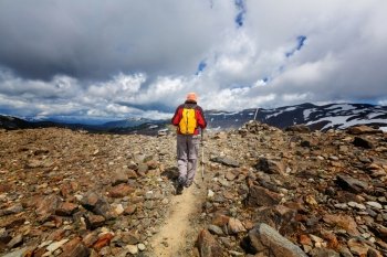 Hike in Canada. Hiking man in Canadian mountains. Hike is the popular recreation activity in North America. There are a lot of picturesque trails.