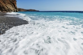 foam  waves splash at stones on shore sea