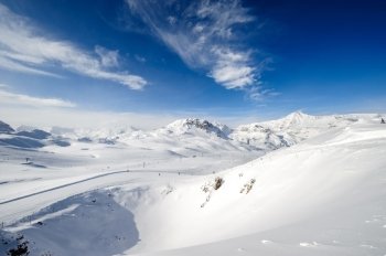 Alpine winter mountain landscape. French Alps covered with snow in sunny day. Val-d'Isere, France