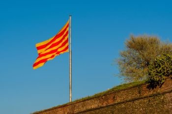 Catalonia flag waving on the wind against sky