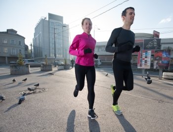 healthy young  couple jogging in the city  at early morning with sunrise in background