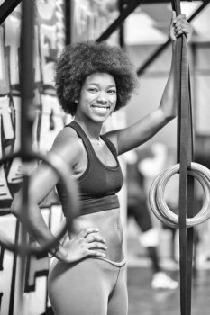 Fitness dip ring african american young woman relaxed after workout at gym dipping exercise