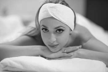 Relaxed young beautiful  woman laying on massage table