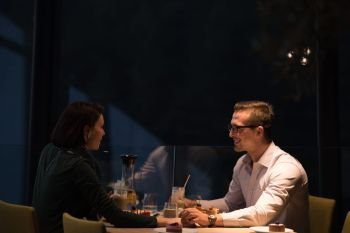 Couple celebrate Valentine’s day with romantic dinner in restaurant near the window