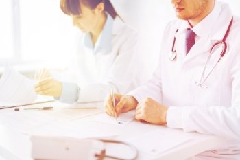 picture of doctor and nurse writing prescription paper. doctor and nurse writing prescription paper