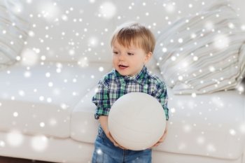childhood and people concept - happy little baby boy with ball at home over snow. happy little baby boy with ball at home