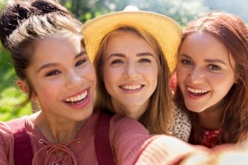leisure, holidays and people concept - happy women or friends taking selfie at summer
