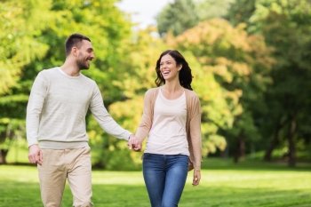 love, relationship, family and people concept - happy couple walking in summer park