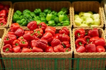 sale, food and vegetables concept - bell peppers or paprika at grocery store or market