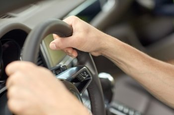 road trip, transport and people concept - close up of male hands driving car and holding wheel