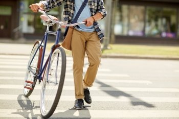 people, style, city life and lifestyle - young hipster man with shoulder bag and fixed gear bike and shoulder bag crossing crosswalk on street