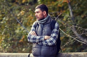 travel, tourism, hike and people concept - man with backpack outdoors