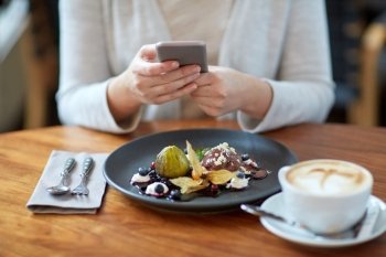 food, new nordic cuisine, technology, eating and people concept - woman with smartphone, chocolate ice cream dessert with blueberry kissel, honey baked fig and yoghurt and coffee sitting at cafe table