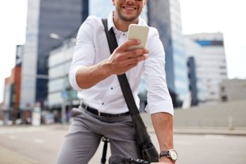 business, people, communication, technology and lifestyle - man texting on smartphone with fixed gear bike on city street