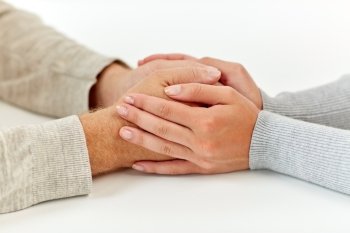 old age, support, charity, care and people concept - close up of senior man and young woman holding hands