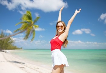 summer holidays, travel, people and vacation concept - happy young woman in sunglasses over exotic tropical beach with palm trees and sea shore background. happy young woman in sunglasses on summer beach
