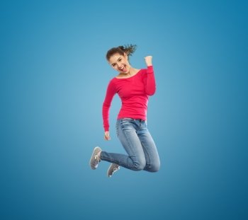 happiness, freedom, motion and people concept - smiling young woman jumping in air over white background. smiling young woman jumping in air