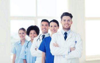 hospital, profession, people and medicine concept - group of happy doctors at hospital. group of happy doctors at hospital