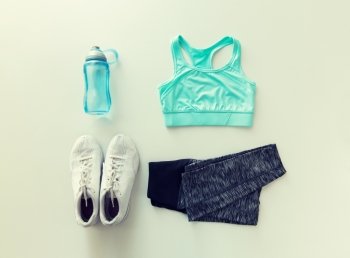 sport, fitness, healthy lifestyle and objects concept - close up of female sports clothing and bottle set. close up of female sports clothing and bottle set