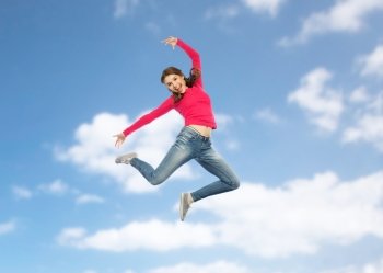 happiness, freedom, motion and people concept - happy young woman jumping or dancing in air over blue sky background. happy young woman jumping in air or dancing