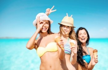 summer holidays, vacation, food, travel and people concept - group of smiling young women eating ice cream on beach over sea and blue sky background. group of smiling women eating ice cream on beach