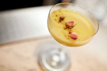 alcohol drinks and luxury concept - glass of cocktail at bar or restaurant. glass of cocktail at bar or restaurant