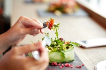 food, culinary, haute cuisine and people concept - woman eating cottage cheese salad with vegetables and dried raspberries at restaurant or cafe. woman eating cottage cheese salad at restaurant