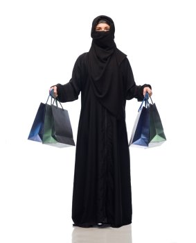 sale, consumerism and people concept - muslim woman in hijab with shopping bags over white background. muslim woman in hijab with shopping bags