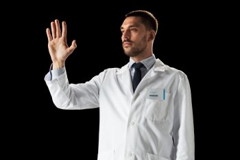 medicine, science, healthcare and people concept - doctor or scientist in white coat touching something invisible over black background. doctor or scientist in white coat
