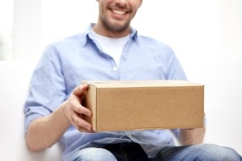 delivery, mail and people concept - happy smiling man with cardboard box or parcel at home. happy man with cardboard box or parcels at home