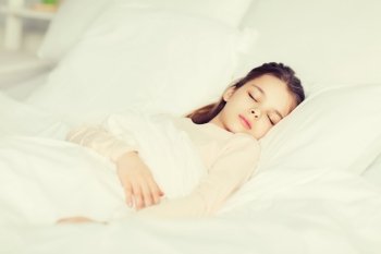 people, children, rest and comfort concept - girl sleeping in bed at home. girl sleeping in bed at home