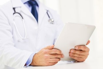 healthcare, technology, profession, people and medicine concept - male doctor in white coat with tablet pc computer at hospital. male doctor in white coat with tablet pc
