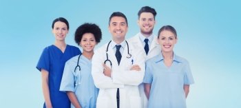 hospital, profession, people and medicine concept - group of happy doctors over blue background. group of happy doctors over blue background