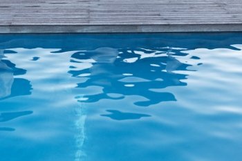 water sport and summer holidays concept - close up of outdoor swimming pool . close up of outdoor swimming pool blue water