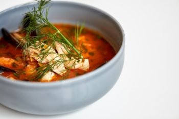 food, new nordic cuisine, culinary and cooking concept - close up of seafood soup with fish and blue mussels in bowl. close up of seafood soup with fish and mussels