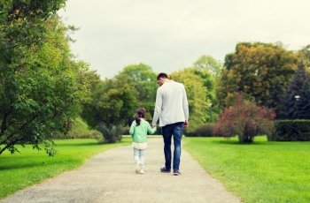 family, parenthood, fatherhood, adoption and people concept - happy father and little girl walking in summer park. happy family walking in summer park