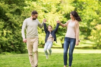family, parenthood, adoption and people concept - happy mother, father and little girl walking in summer park and having fun. happy family walking in summer park and having fun