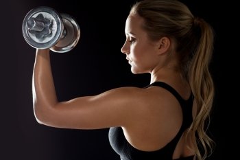 sport, fitness and people concept - young sporty woman exercising with dumbbell. young sporty woman exercising with dumbbell. young sporty woman exercising with dumbbell