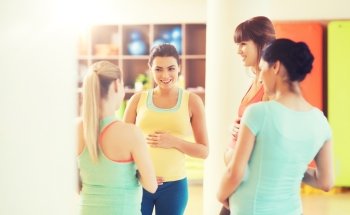 pregnancy, sport, fitness, people and healthy lifestyle concept - group of happy pregnant women talking in gym. group of happy pregnant women talking in gym. group of happy pregnant women talking in gym