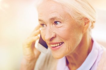 technology, communication age and people concept - happy senior woman with smartphone calling at home. senior woman with smartphone calling at home. senior woman with smartphone calling at home