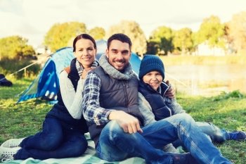 camping, tourism, hike and people concept - happy family over tent at camp site. happy family with tent at camp site. happy family with tent at camp site