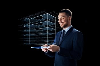 business, people and future technology concept - smiling businessman in suit working with transparent tablet pc computer and virtual construction hologram over black background. businessman with tablet pc and virtual building. businessman with tablet pc and virtual building